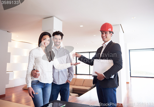 Image of couple buying new home with real estate agent