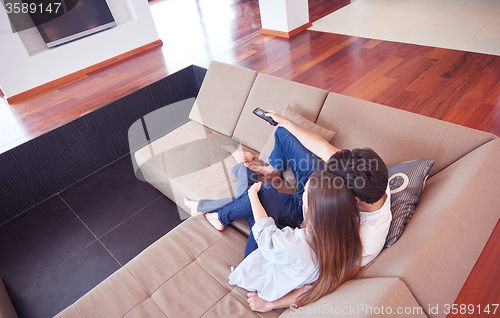 Image of young couple watching tv at home
