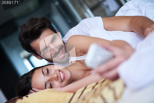 Image of couple relax and have fun in bed