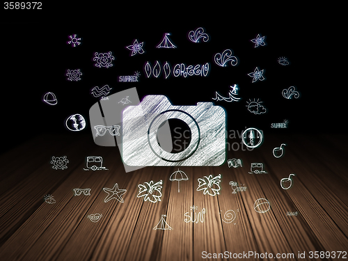 Image of Tourism concept: Photo Camera in grunge dark room