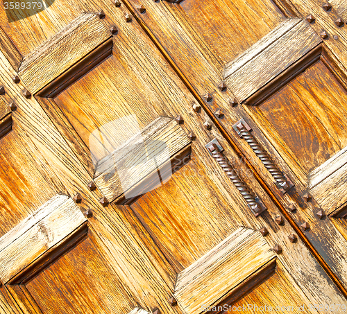 Image of abstract texture of a brown antique wooden old door in italy eur