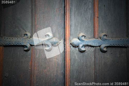 Image of handle in london antique brown door  rusty  brass nail and light