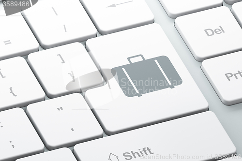 Image of Tourism concept: Bag on computer keyboard background