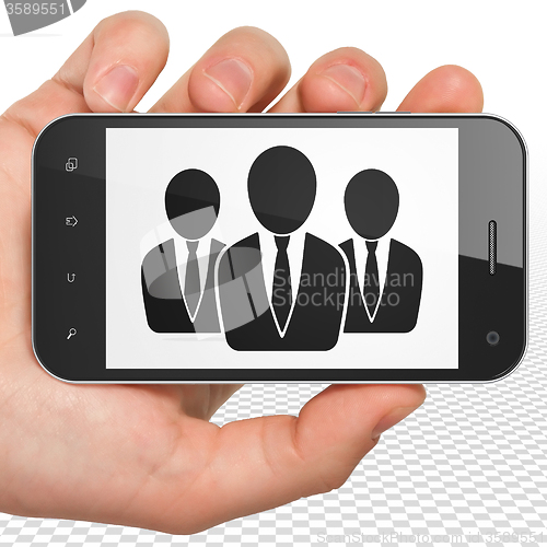 Image of Business concept: Hand Holding Smartphone with Business People on display