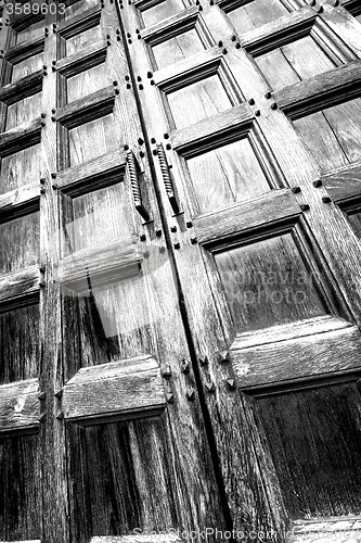 Image of abstract texture of a brown antique wooden old door in italy   e