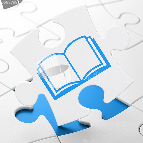 Image of Science concept: Book on puzzle background