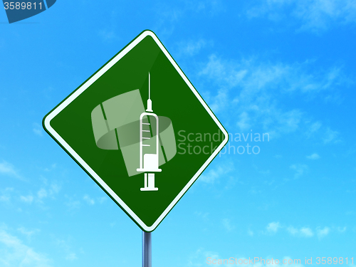 Image of Medicine concept: Syringe on road sign background