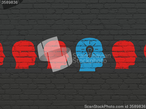 Image of Business concept: head with light bulb icon on wall background