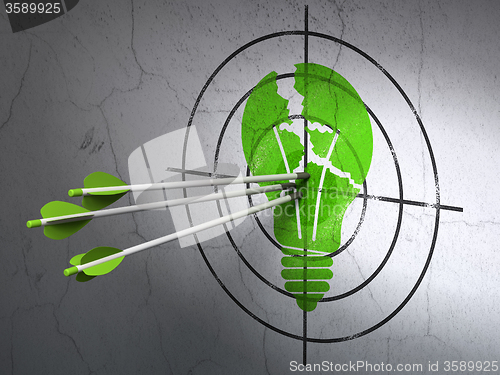 Image of Business concept: arrows in Light Bulb target on wall background