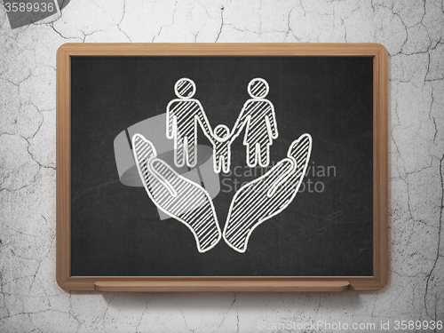 Image of Insurance concept: Family And Palm on chalkboard background