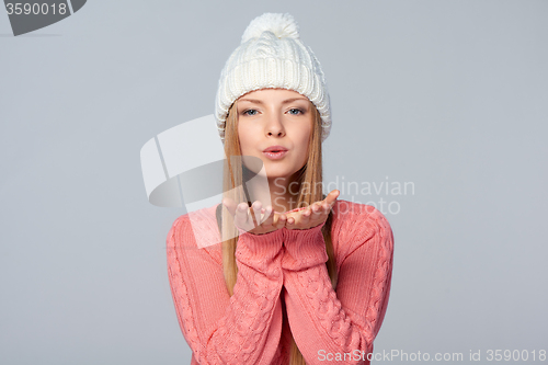 Image of Woman blowing a kiss