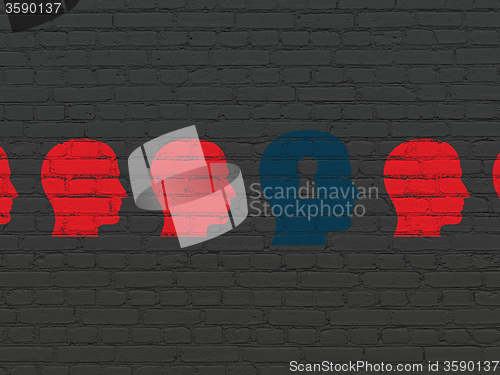 Image of Learning concept: head with keyhole icon on wall background