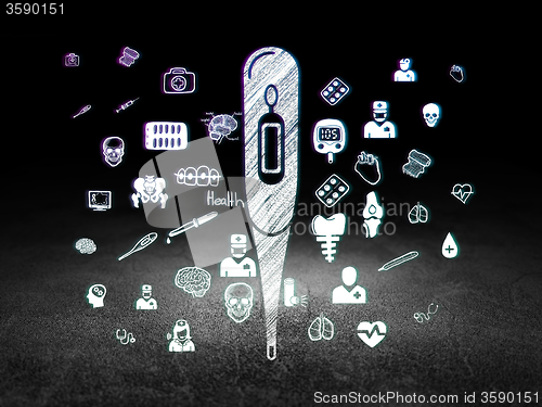 Image of Medicine concept: Thermometer in grunge dark room