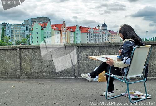 Image of Street artist paints Fishing Village. Kaliningrad. Russia