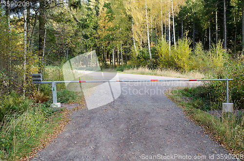 Image of one small road with a road barriier 