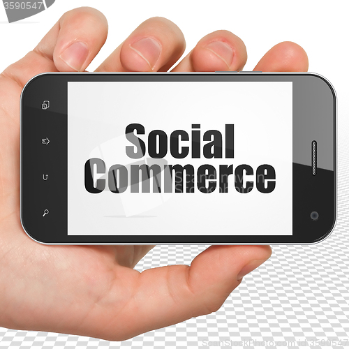 Image of Marketing concept: Hand Holding Smartphone with Social Commerce on display