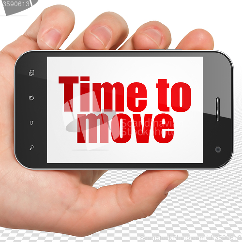 Image of Time concept: Hand Holding Smartphone with Time to Move on display