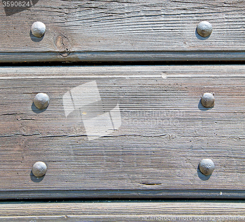Image of abstract texture of a brown antique wooden old door in italy   e