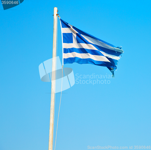 Image of waving greece flag in the blue sky and flagpole