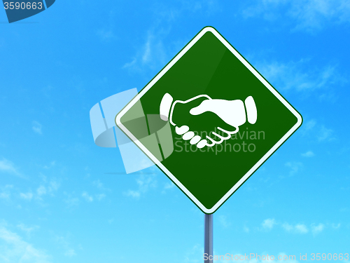 Image of Finance concept: Handshake on road sign background