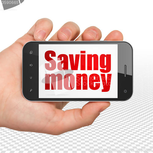 Image of Business concept: Hand Holding Smartphone with Saving Money on display