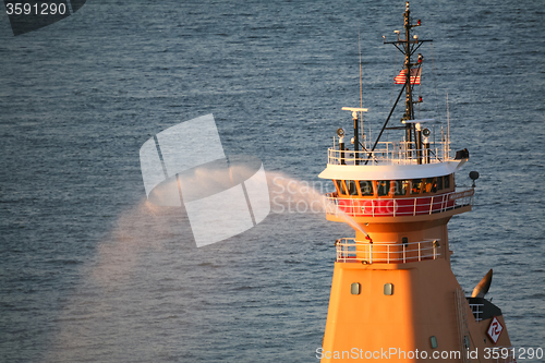 Image of Tugboat spraying water in East River