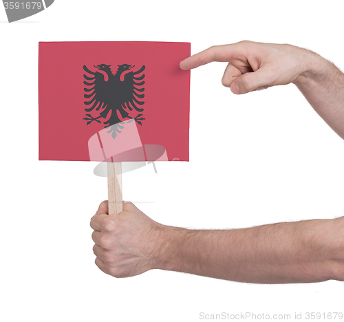 Image of Hand holding small card - Flag of Albania