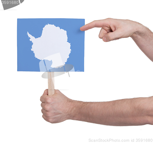Image of Hand holding small card - Flag of Antarctica