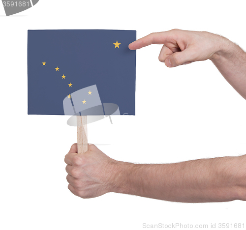 Image of Hand holding small card - Flag of Alaska