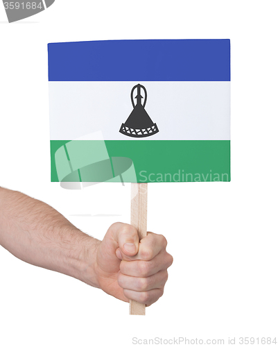 Image of Hand holding small card - Flag of Lesotho