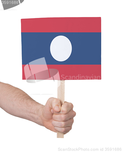 Image of Hand holding small card - Flag of Laos