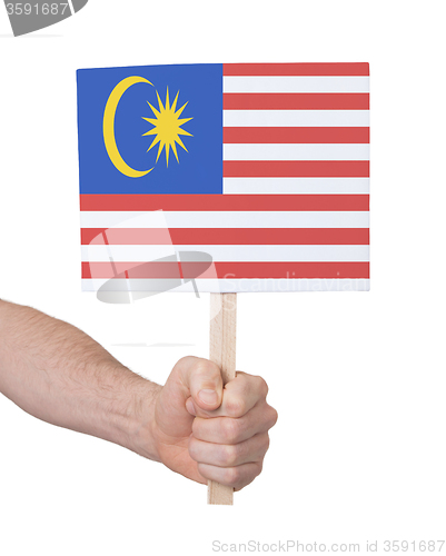 Image of Hand holding small card - Flag of Malaysia