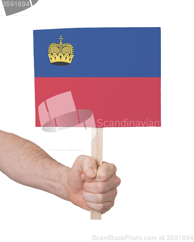 Image of Hand holding small card - Flag of Liechtenstein