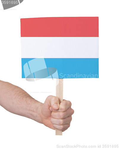 Image of Hand holding small card - Flag of Luxembourg