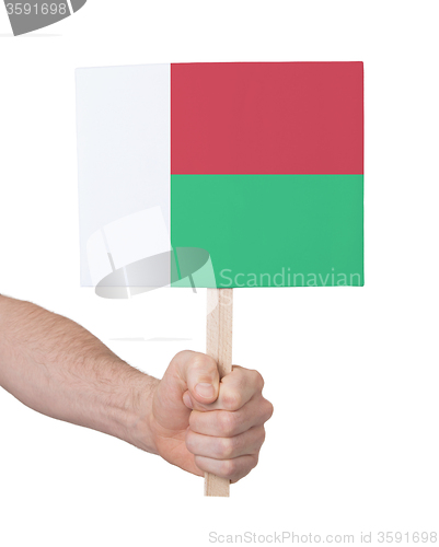 Image of Hand holding small card - Flag of Madagascar