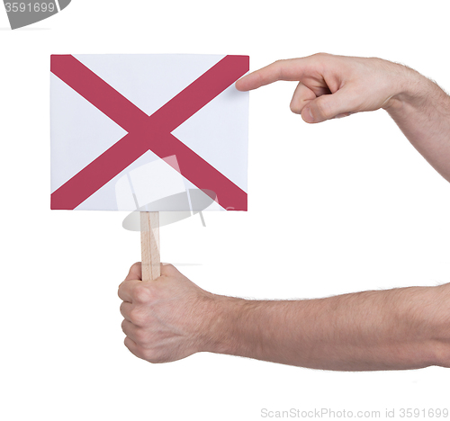 Image of Hand holding small card - Flag of Alabama
