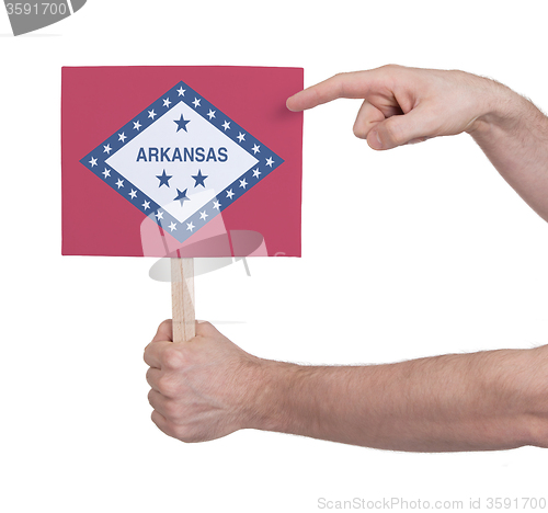 Image of Hand holding small card - Flag of Arkansas