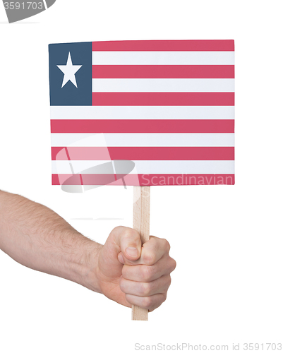 Image of Hand holding small card - Flag of Liberia