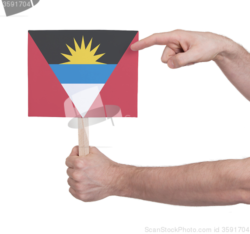 Image of Hand holding small card - Flag of Antigua and Barbuda