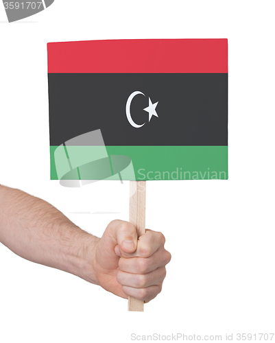 Image of Hand holding small card - Flag of Libya