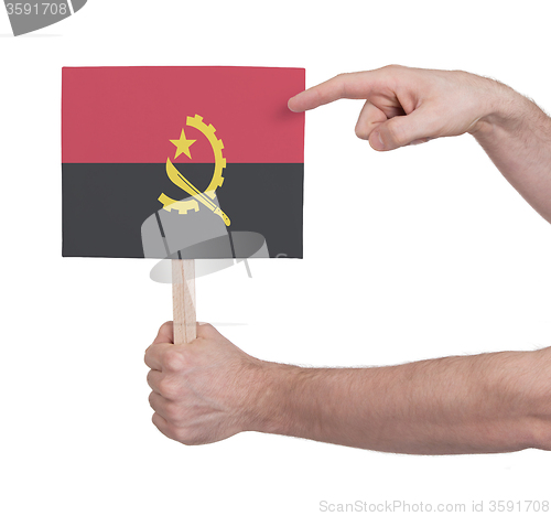 Image of Hand holding small card - Flag of Angola