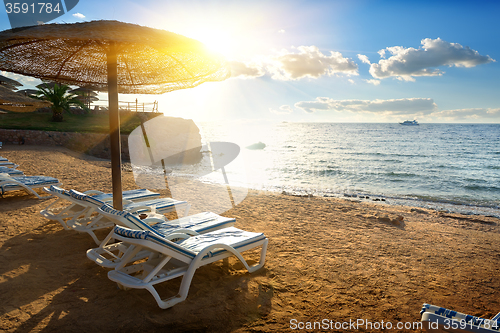 Image of Chaise-longues on a beach