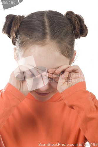 Image of Young girl covering her face