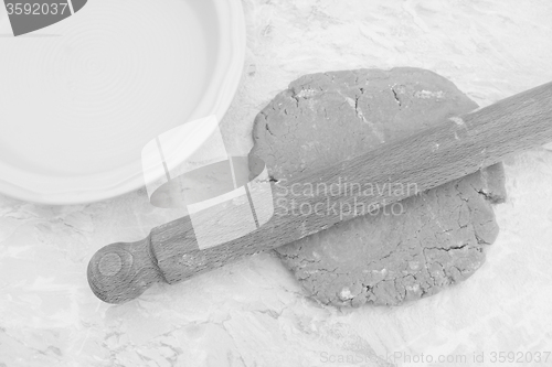 Image of Rolling out homemade pastry with a rolling pin