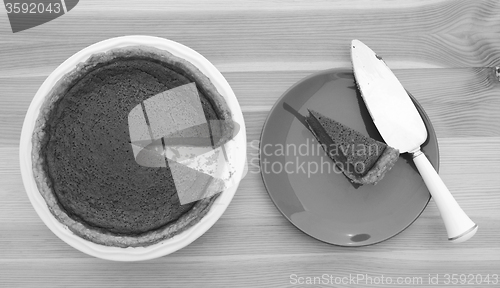 Image of Slice taken from a pumpkin pie with pie server