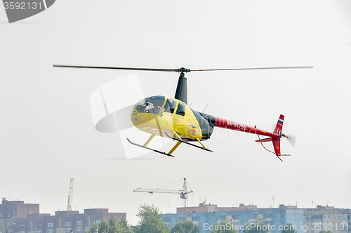 Image of Pilot of Robinson R44 Raven over city