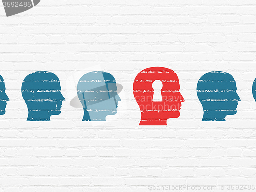 Image of Education concept: head with keyhole icon on wall background