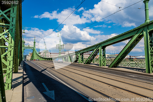 Image of The green Freedom Bridge, with yellow tram, in Budapest,the capi