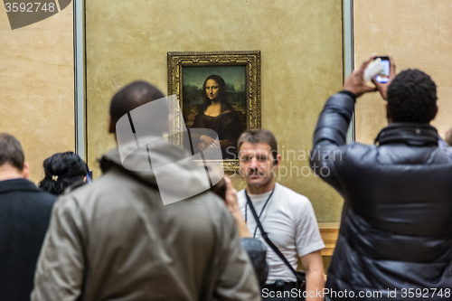 Image of Visitors take photo of Leonardo DaVinci\'s \"Mona Lisa\" at the Lou