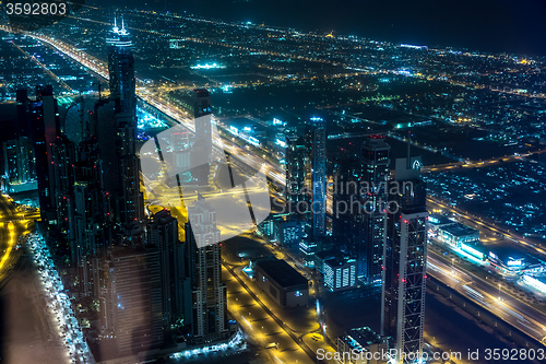 Image of Dubai downtown night scene with city lights,